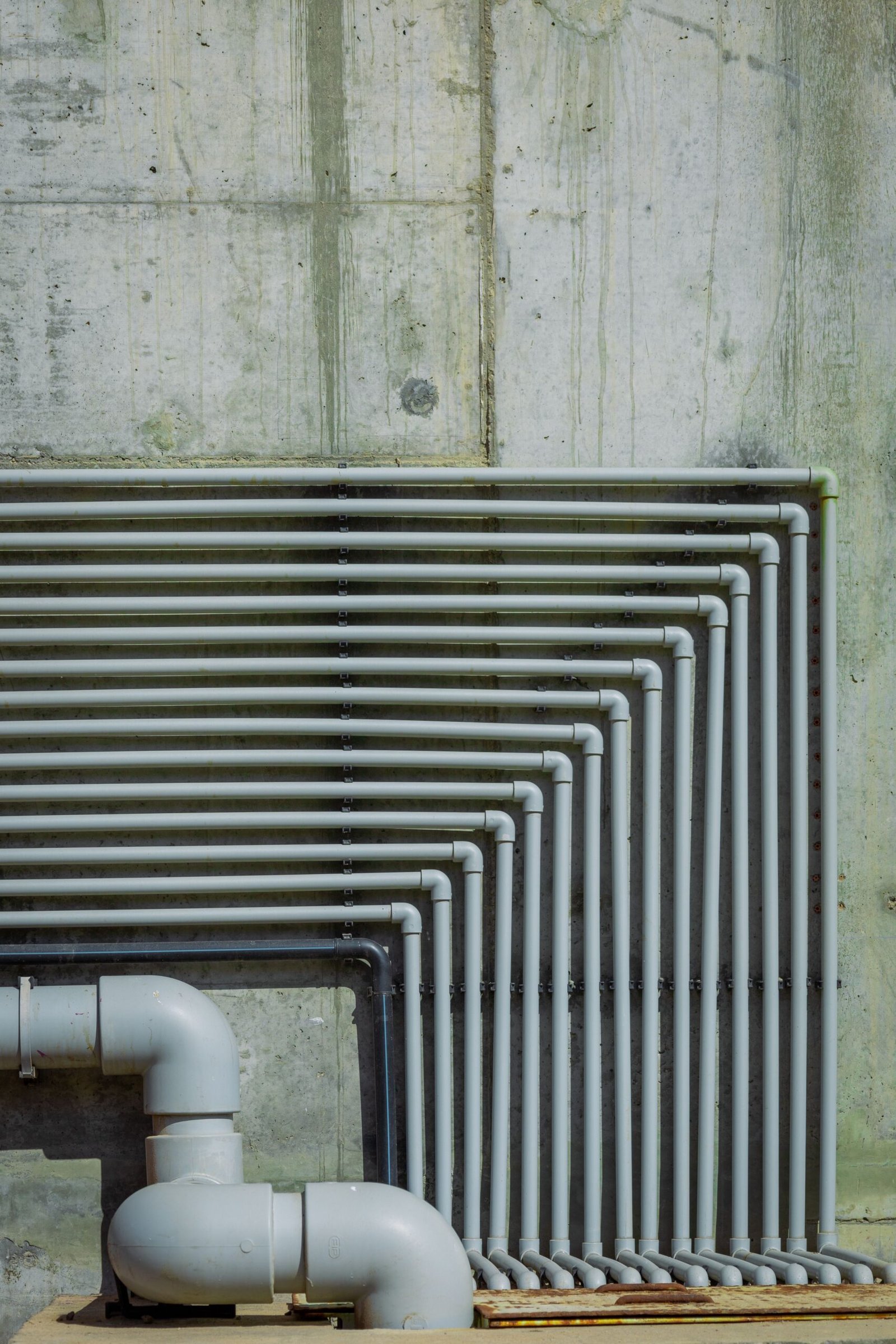 Row of drain pipes mounted along an exterior wall, Los Angeles CA