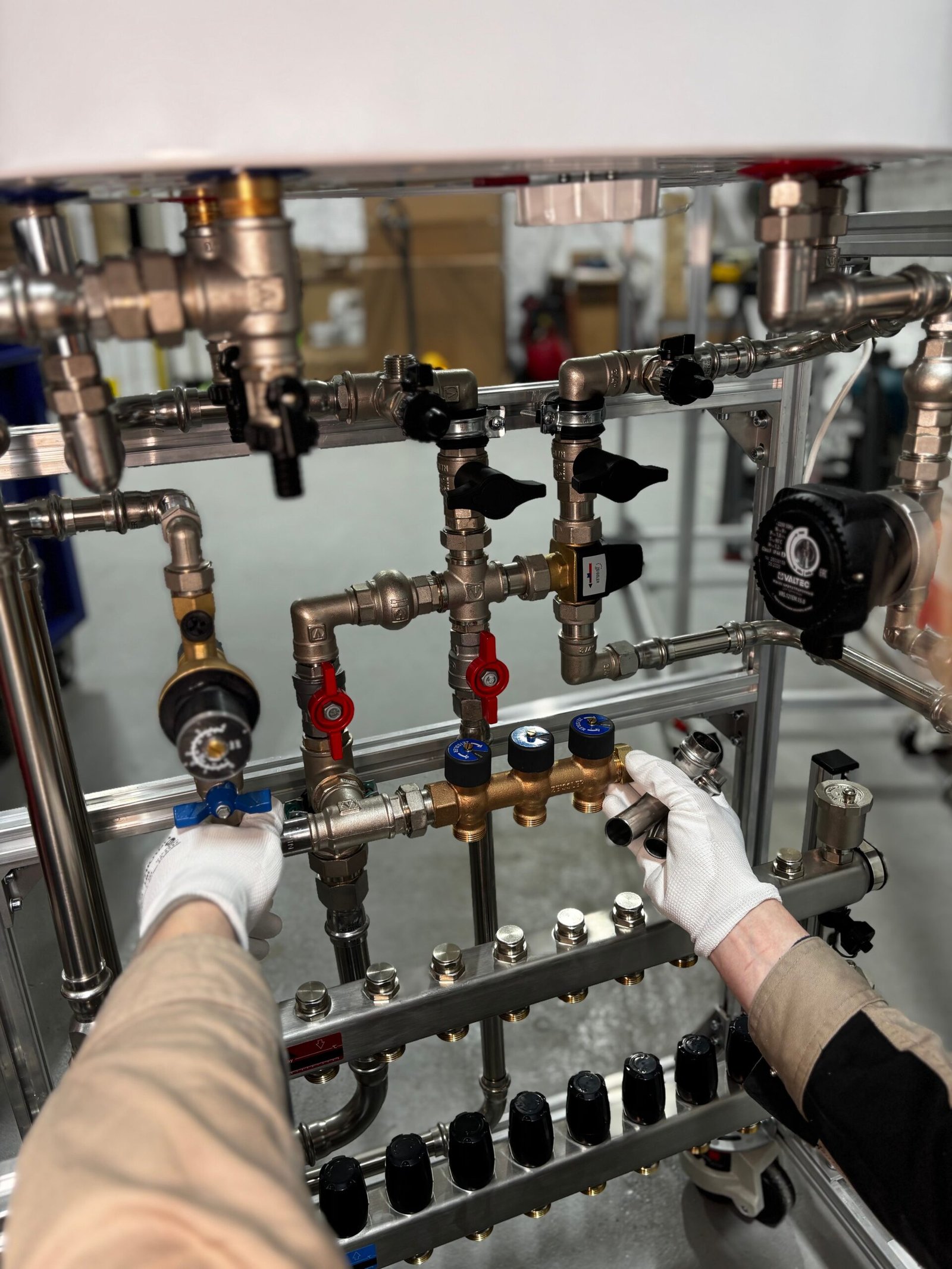 Plumber adjusting a manifold of shutoff valves, Los Angeles CA